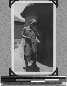 A girl is playing the 'violin' near Tabase, South Africa East, 1933-12-19