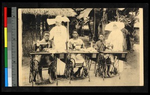 Missionary sisters standing by women with sewing machines, Congo, ca.1934