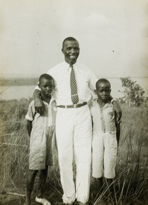 Congolese Christian and two boys, Congo, ca. 1920-1930