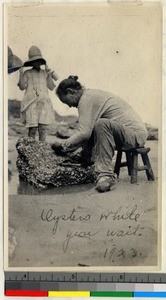 Woman preparing oysters at summer resort near Haizhou, Jiangsu, China, 1923