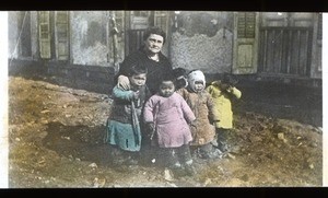 Woman sitting with children, China, ca. 1920-1940