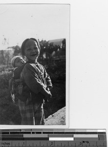 One orphan carries another at Liantan, China, 1935