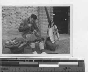 A tailor working in the street at Guangzhou, China, 1927