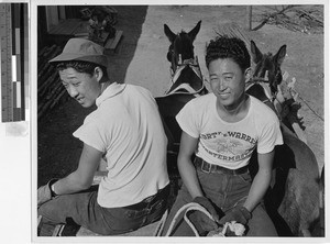 Two boys traveling by wagon, Jerome Relocation Center, Denson, Arkansas, November 17, 1942