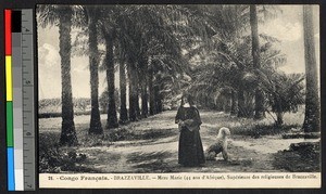 Catholic missionary sister standing in a palm-lined road, Brazzaville, Congo, ca.1920-1940