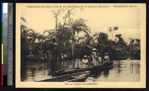 Missionary sisters ride in a canoe with children, Benin, ca. 1900-1930