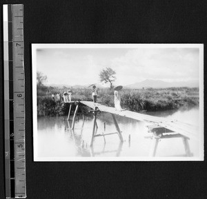 Fukien Christian University students crossing a footbridge, Fuzhou, Fujian, China, 1938