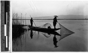 Two fishermen in a small boat, Japan, ca. 1920-1940