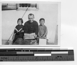 Fr. Eggleston and two children in Meixien, China, 1949