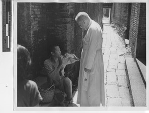 Fr. Paulhus with blind man at Xinhui, China, 1947