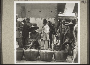 Market for rice. The Chinese carry their dried rice to market in baskets like these. It is then sold either on a special open space