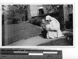 A Maryknoll Sister with a child at Guilin, China, 1949