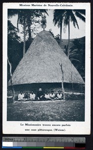 Missionary father sits with children in front of a thatched dome, New Caledonia, ca.1900-1930