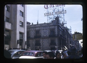 Ancient "House of Tiles" (glazed) in shadow of a modern bank building