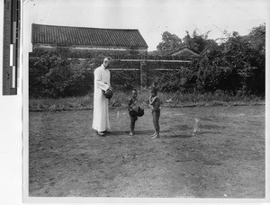 Fr. Maurice A. Feeney with two young boys in Jiangmen, China, 1948