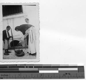 A man delivers a baby to Maryknoll Sister at Luoding, China, 1938