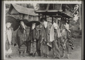 Masked dancers at a funerary celebration. They come into the house of the deceased before the burial