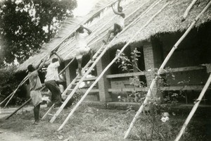 Catechists repairing a roof, in Gabon