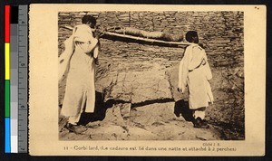 Two men carrying a corpse on a stretcher, Ethiopia, ca.1920-1940