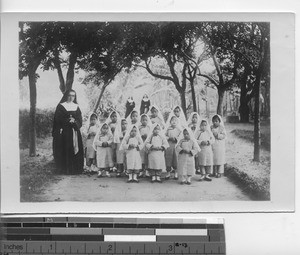 Sisters with small orphans in China, ca.1900