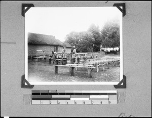 Men cleaning pews, Nyasa, Tanzania, 1936