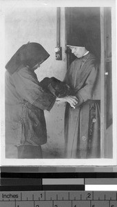 Sister receives an orphan, Yeung Kong, China, ca. 1930