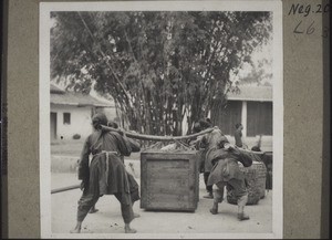 In this way heavy crates are carried by groups of four or five women