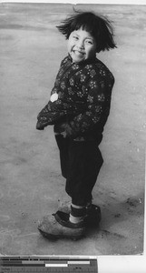 A girl in her father's shoes at Fushun, China, 1937