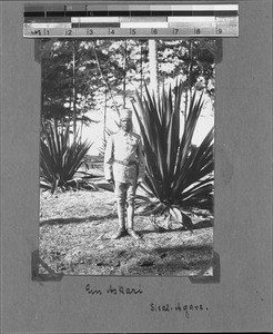 Askari in front of a sisal plant, Nyasa, Tanzania