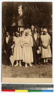 Bride and groom standing outdoors with wedding party, Tanganyika, ca.1920-1940