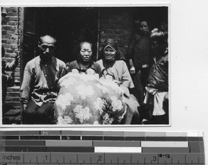 Maryknoll Sister with parents of triplets at Fushun, China