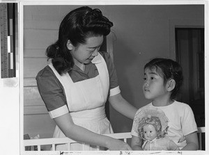 Nurses aid Chiyo Okata tends to Reiko Masado at Jerome Relocation Center hospital, Denson, Arkansas, March 11, 1943