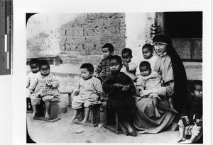 A Maryknoll Sister with children from the orphanage at Luoding, China