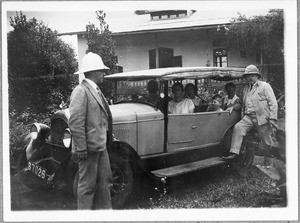 Missionaries with their families at a car, Mwika, Tanzania, ca. 1927-1930