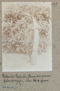 Mukamba Matsilu Ikusa with an elephant tooth, more than 100 pounds heavy