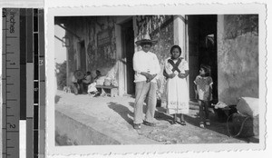 Family standing in front of the entrance to a building, Mexico, ca. 1943