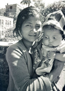 Nepal 1986. A young mother with her baby outside the United Mission Hospital Tansen