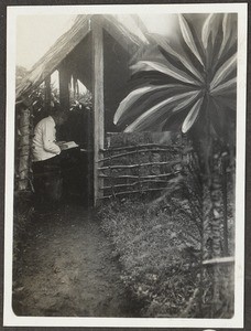 Missionary Fritze reading in the vestry, Tanzania, ca.1926-1944