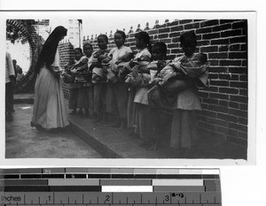 Young Chinese girls care for orphaned babies at Luoding, China, 1933