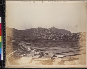 View of rice fields with city of Antananarivo in distance, Madagascar, ca. 1870