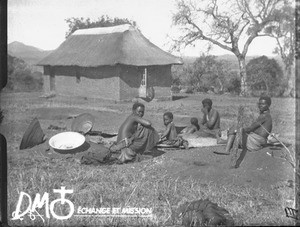 African women preparing food in front of a chapel/school, Kouroulene, South Africa, April 1915