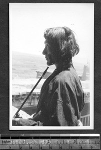 Tibetan man with a pipe, Tibet, China, ca.1941