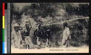 Missionary father and line of porters, French Equatorial Africa, ca.1920-1940