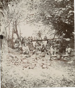 Girls of Rapa island preparing the 'popoï' (taro), in the middle of the river