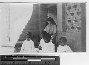 A Maryknoll Sister with blind girls at the orphanage at Luoding, China