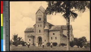 People standing before a large brick church, Congo, ca.1920-1940