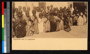 Rows of children kneeling in prayer, Eritrea, ca.1920-1940