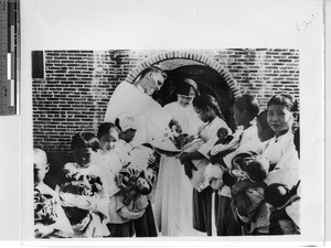 Abandoned children being baptized at the orphanage at Luoding, China, 1935