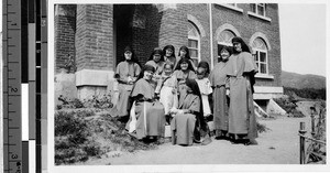 Group portrait of ten Maryknoll Sisters and two Korean children at Maryknoll convent, Yeng You, Korea, May 18, 1930