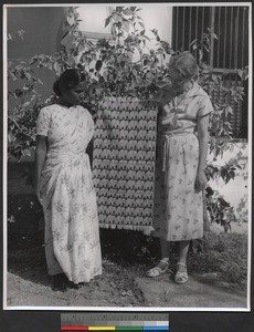 Woman showing a length of woven cloth, India, ca.1919-1943